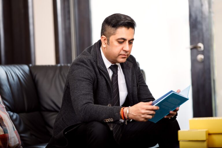 A founder sitting at a desk in natural light with a notebook and laptop, reflecting on decisions and challenges. The image represents the human side of entrepreneurship, decision fatigue and the realities of building businesses.